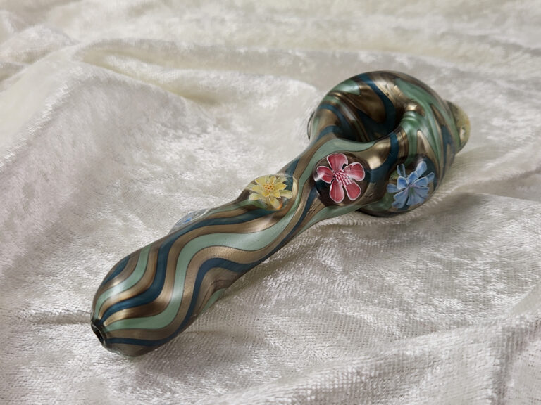 Glass spoon pipe with wavy stripes and murrine flowers