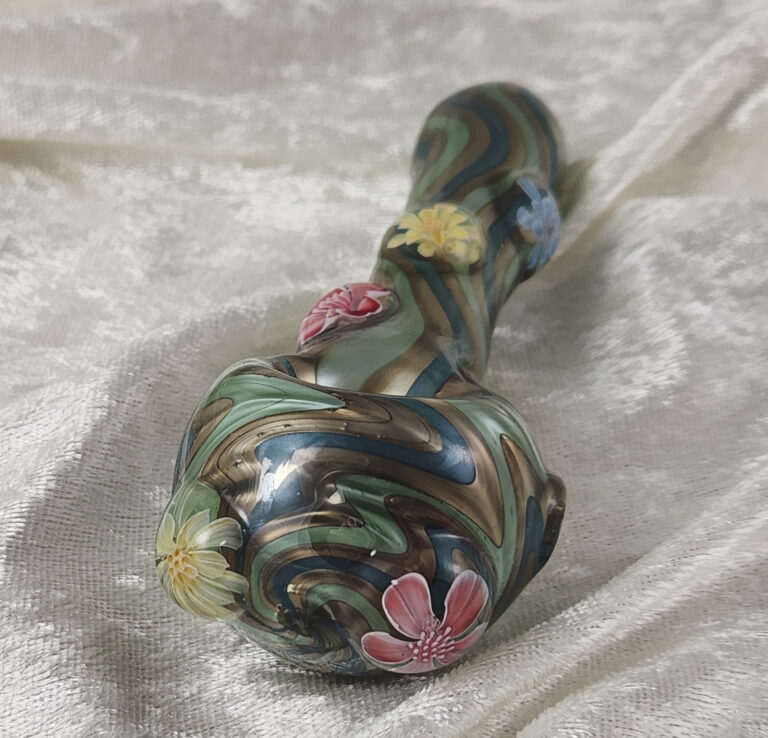 Glass spoon pipe with green and blue swirls and murrine flowers