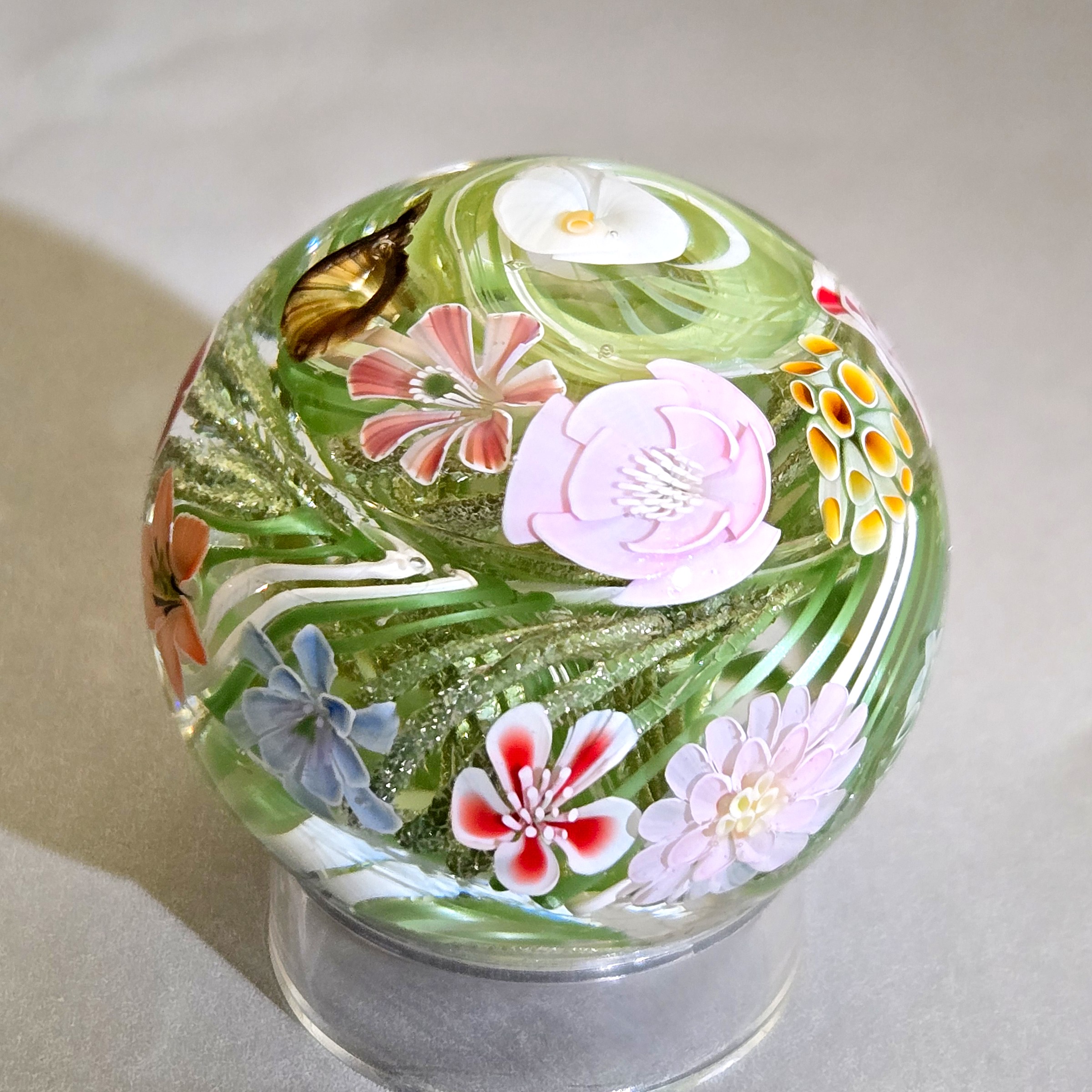Flower vortex marble, 44mm, with 21 three-dimensional flowers around a green and white core, view 1
