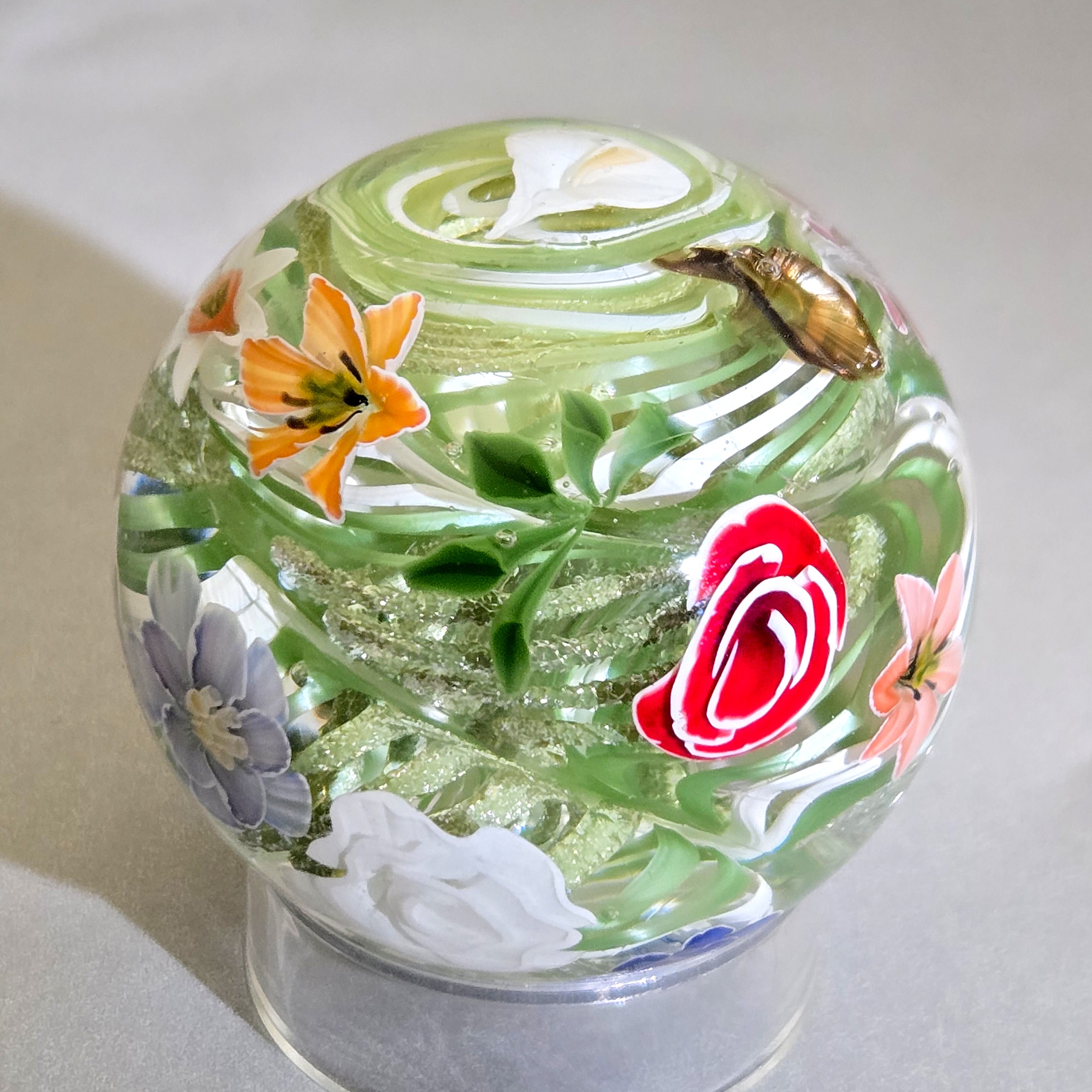 Flower vortex marble, 44mm, with 21 three-dimensional flowers around a green and white core, view 3