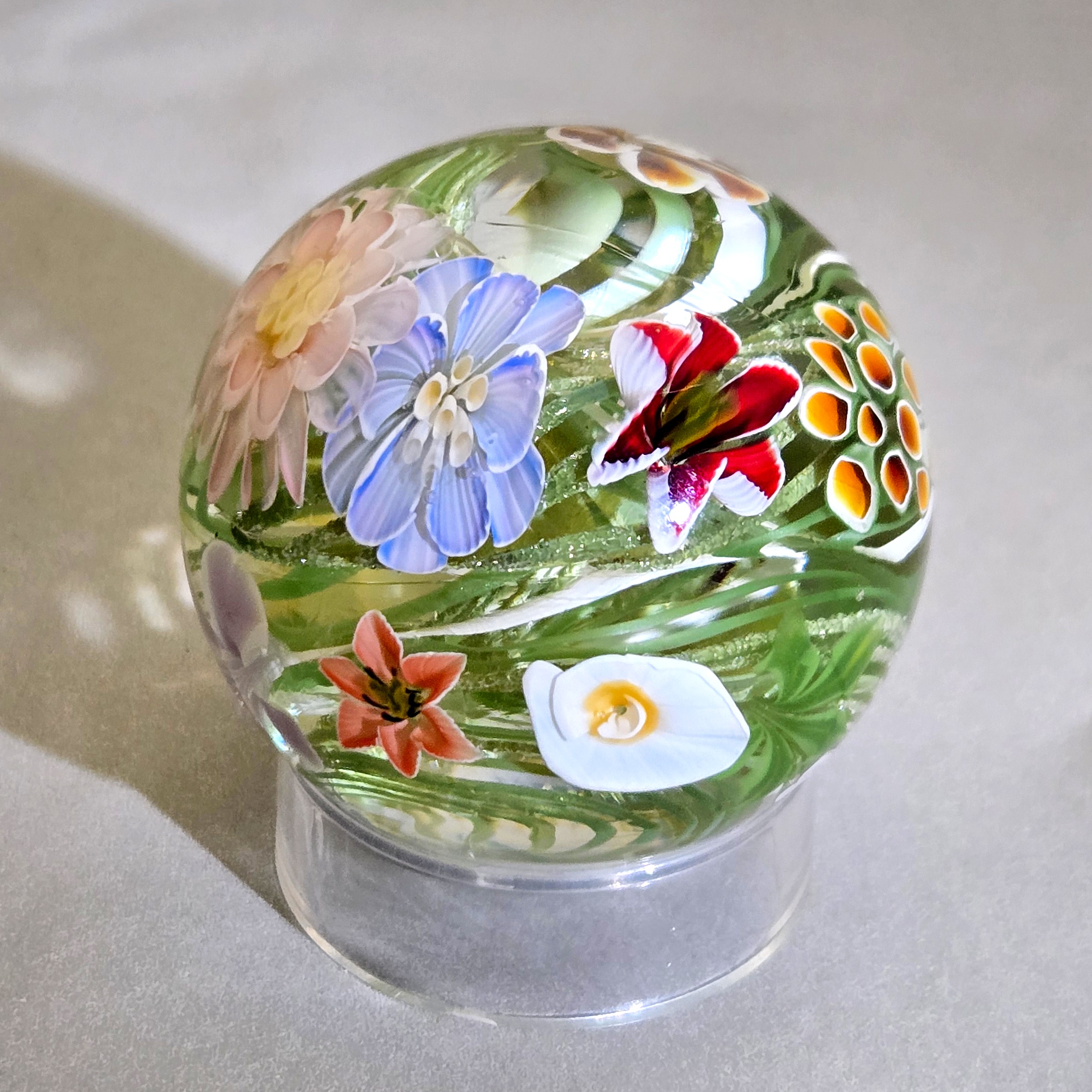 Flower vortex marble, 41mm, with 17 three-dimensional flowers around a green and white core, view 2