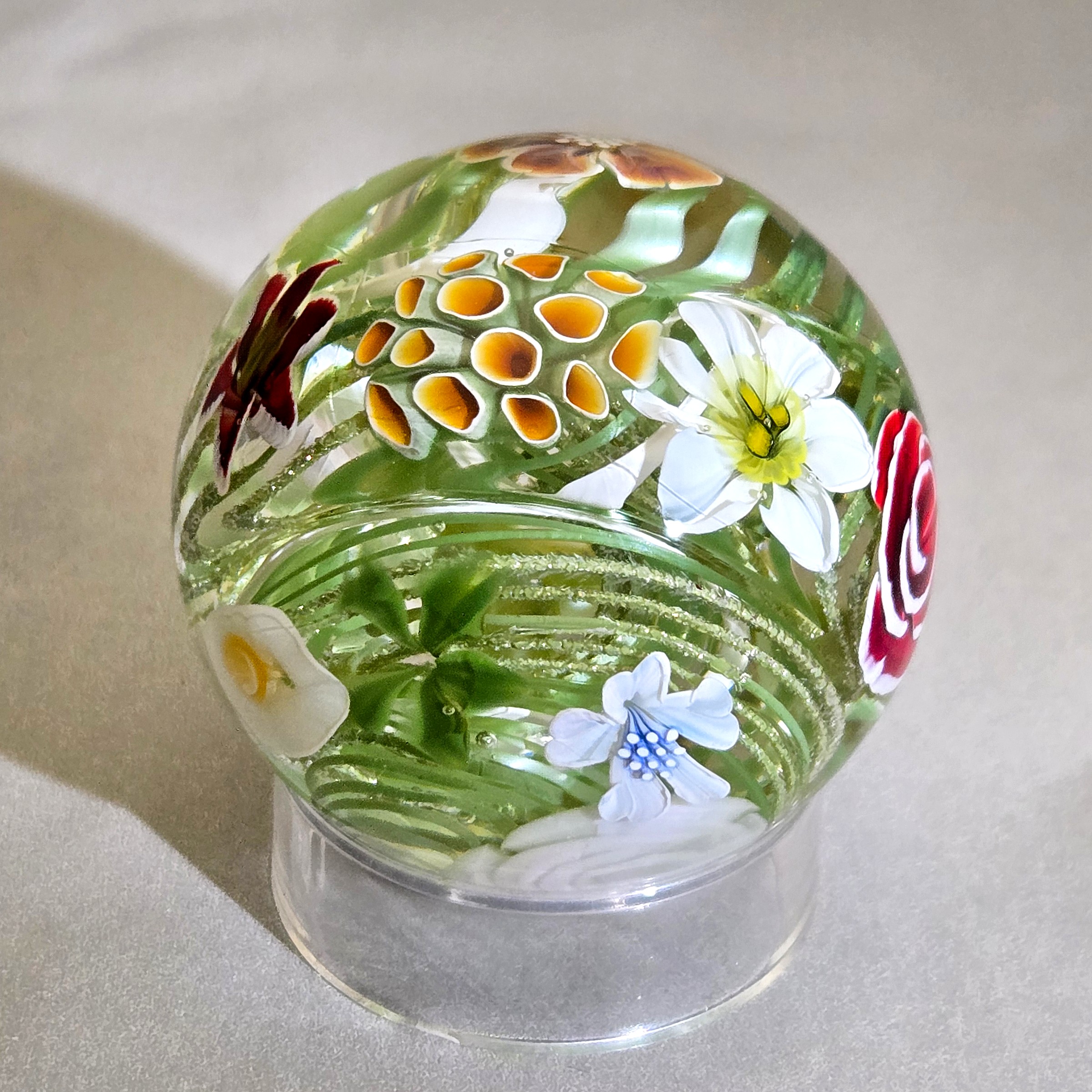 Flower vortex marble, 41mm, with 17 three-dimensional flowers around a green and white core, view 3