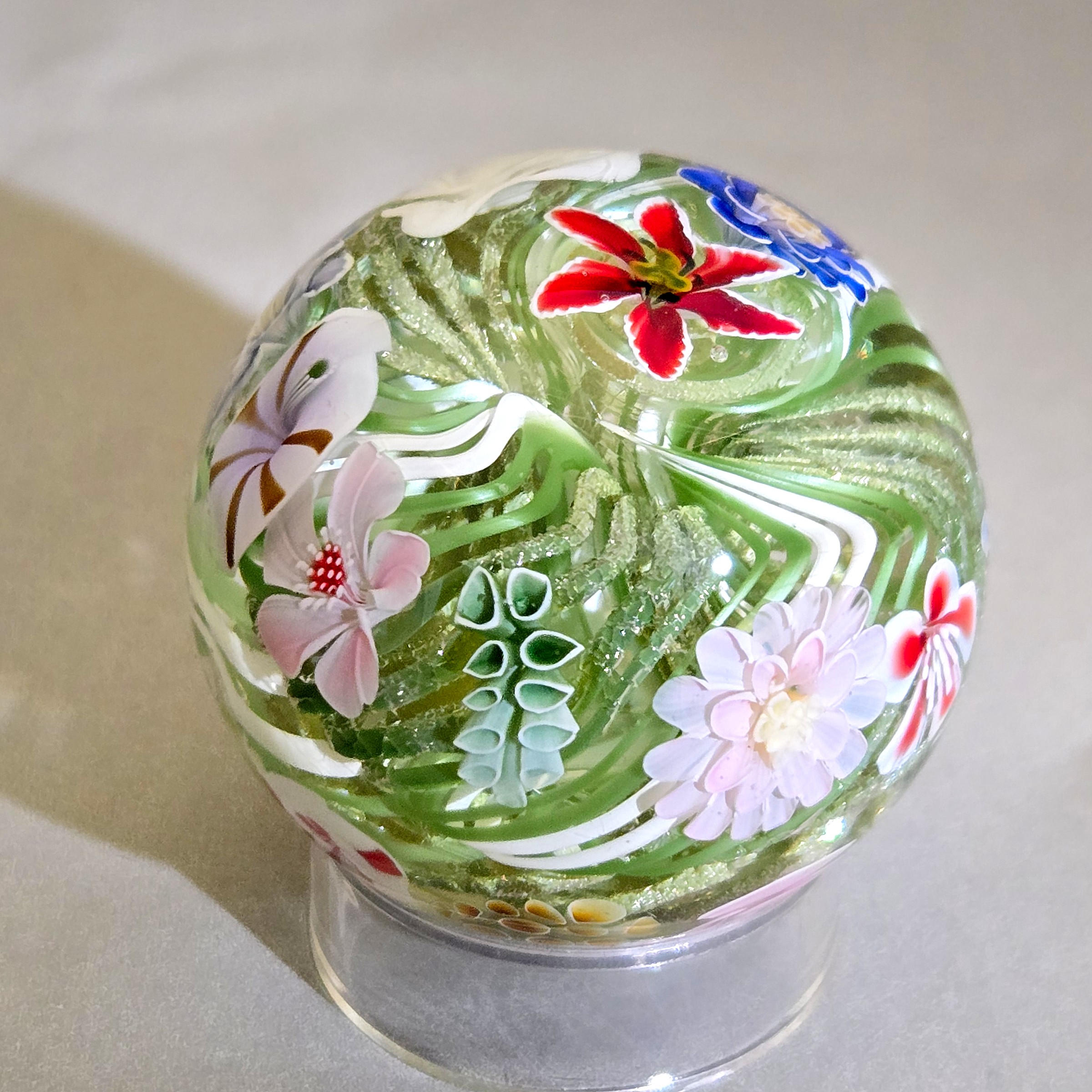 Flower vortex marble, 44mm, with 21 three-dimensional flowers around a green and white core, view 5